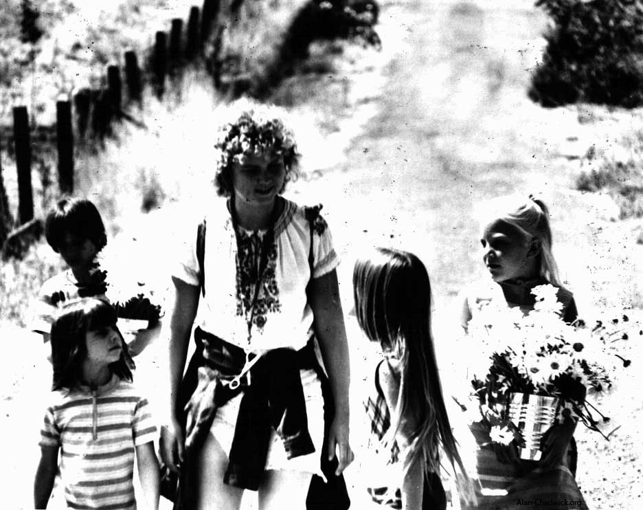 Anna (Peck) Rainville leads an enthustiastic group of children in activities at the Saratoga Community Garden