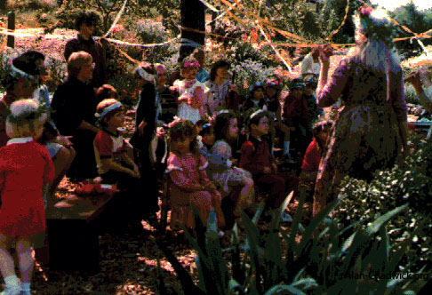 The May Queen (Betty Peck) leads the Maypole ceremony.